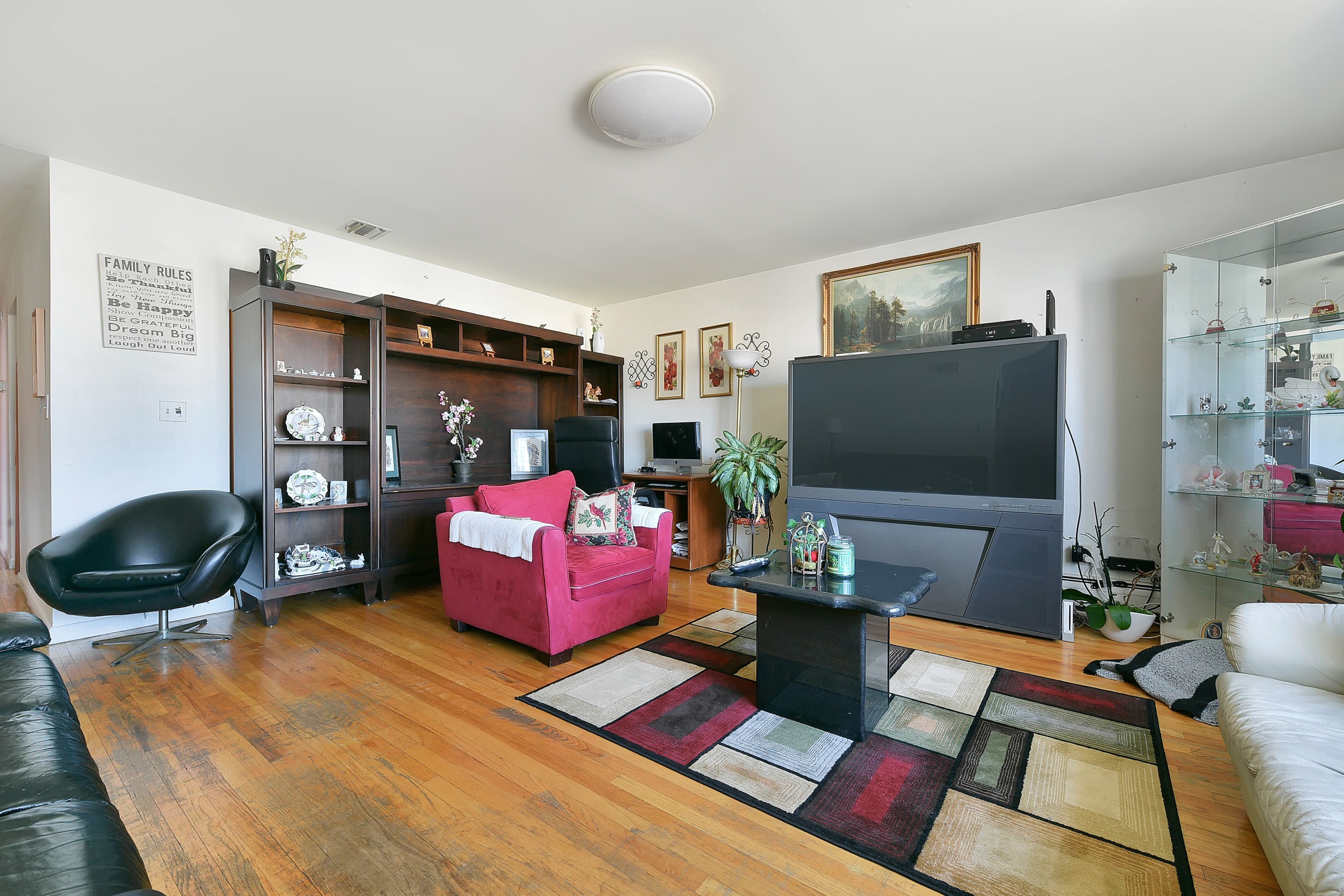 136 oakwood ave cliffside park nj 07010 living room with wide screen and red sofa