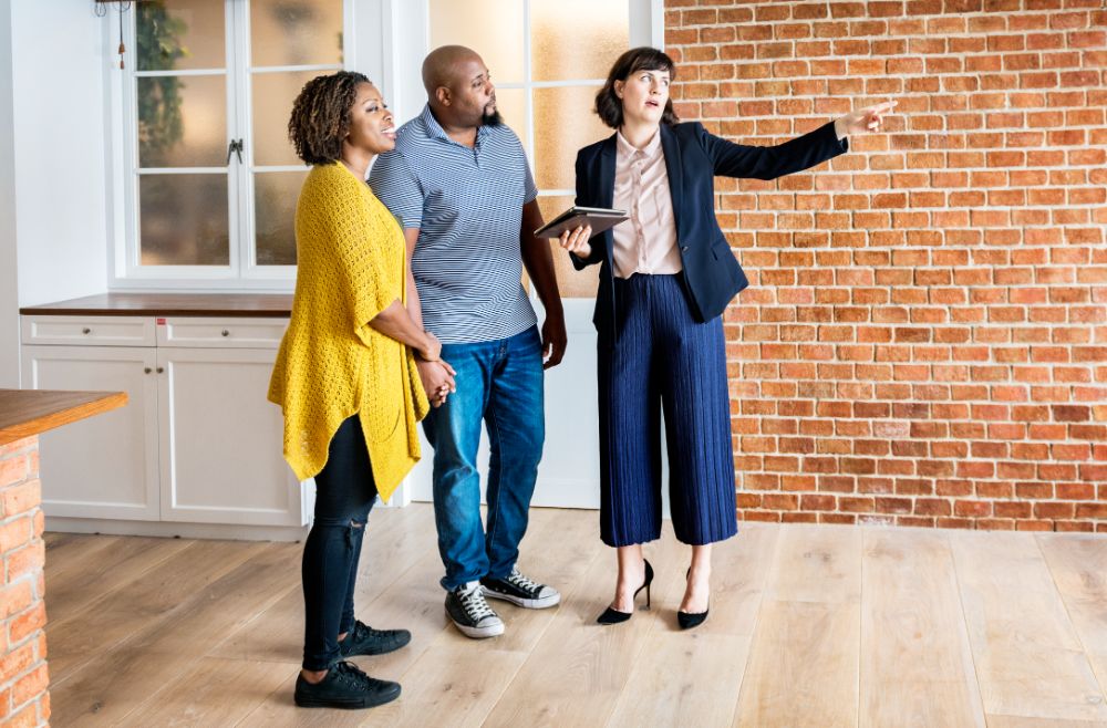 couple and agent in an open house session