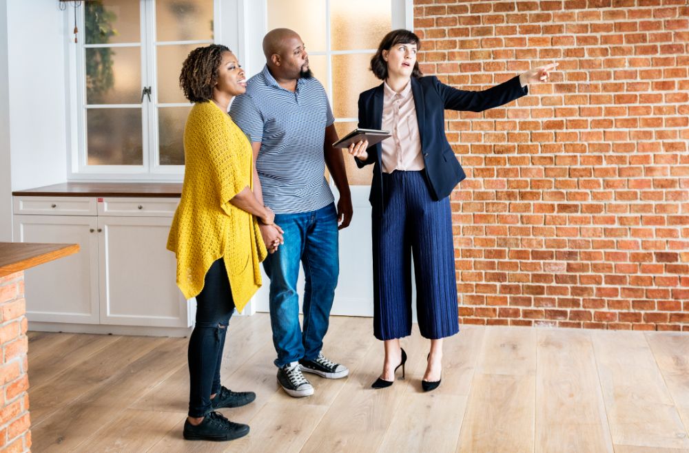 couple and agent in an open house session