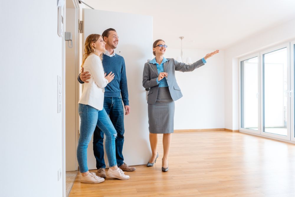 couple and real estate agent during an open house